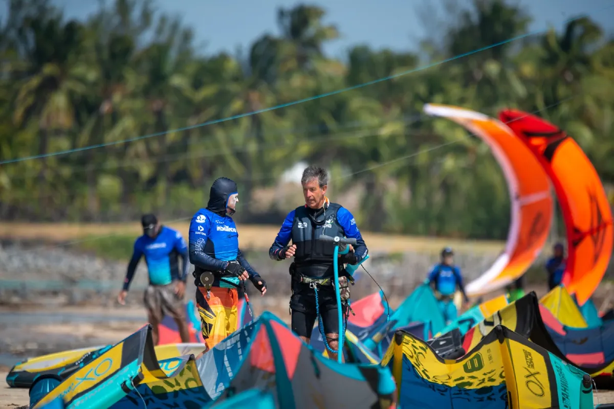 pessoas na praia organizando o kite