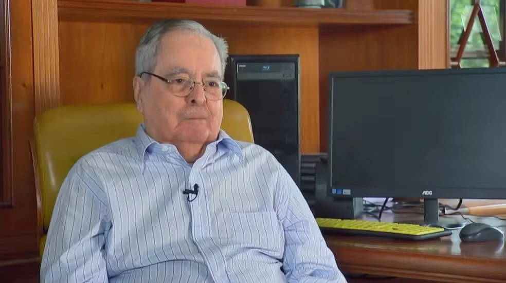 homem sentado dando entrevista